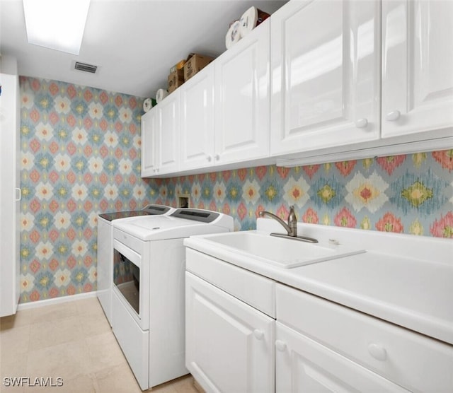 9811 Gulf Shore Dr Unit 301, Naples, FL 34108 - laundry area featuring washing machine and clothes dryer, wallpapered walls, and cabinet space