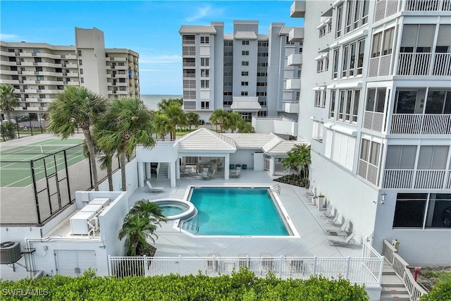 view of swimming pool featuring a gazebo, a community hot tub, central air condition unit, and a patio area