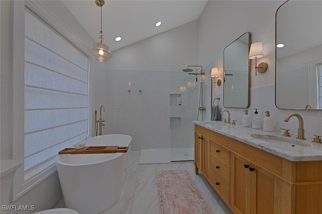 bathroom featuring lofted ceiling, vanity, independent shower and bath, and tile walls