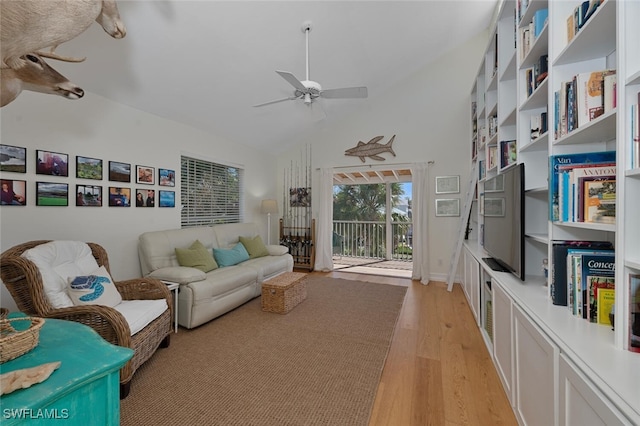 interior space featuring ceiling fan, high vaulted ceiling, and light wood-type flooring