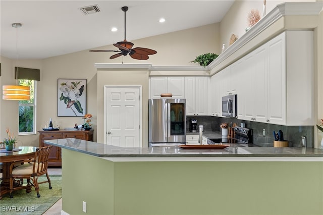 kitchen with appliances with stainless steel finishes, decorative light fixtures, tasteful backsplash, white cabinetry, and kitchen peninsula