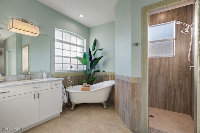 bathroom featuring vanity, tile patterned flooring, independent shower and bath, and tile walls