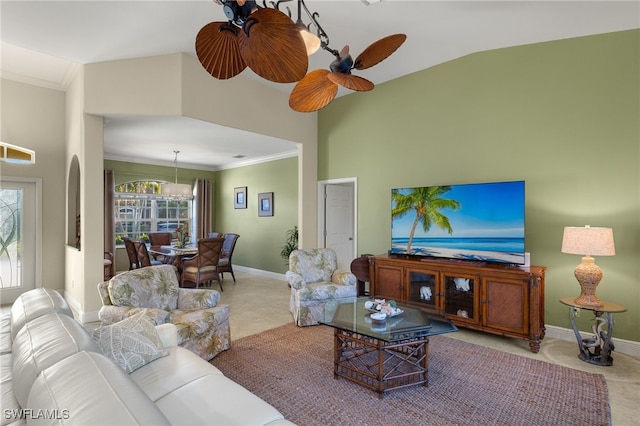 living room featuring crown molding, ceiling fan, and carpet flooring