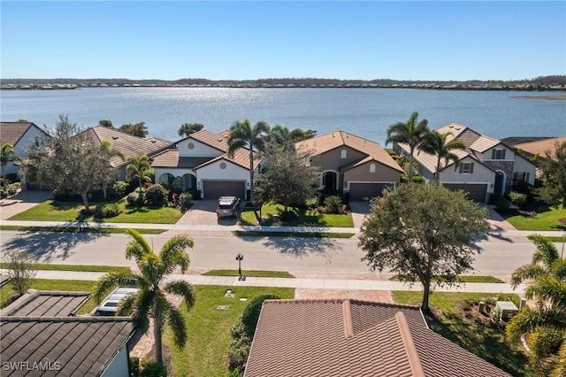 birds eye view of property with a water view