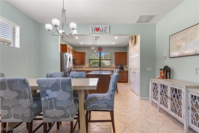 dining area with a notable chandelier, a wealth of natural light, and light tile patterned floors