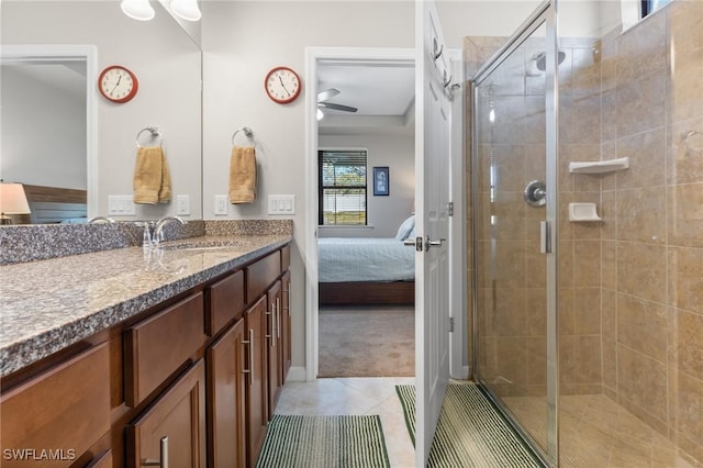 bathroom featuring tile patterned flooring, vanity, and a shower with door