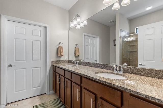 bathroom with an enclosed shower, vanity, and tile patterned floors