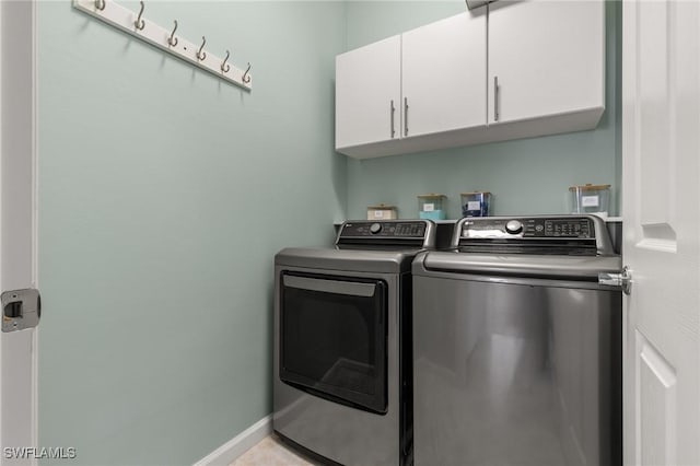 laundry room featuring cabinets and separate washer and dryer