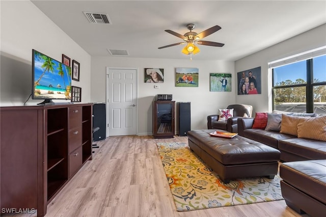 living room with ceiling fan and light hardwood / wood-style flooring