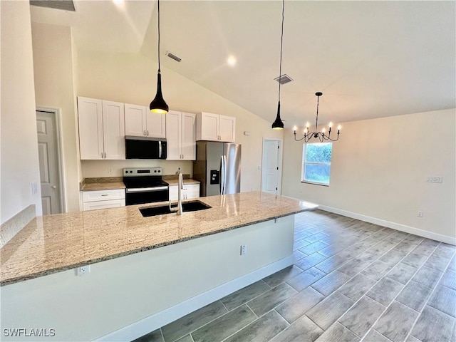 kitchen featuring light stone counters, sink, stainless steel appliances, and white cabinets