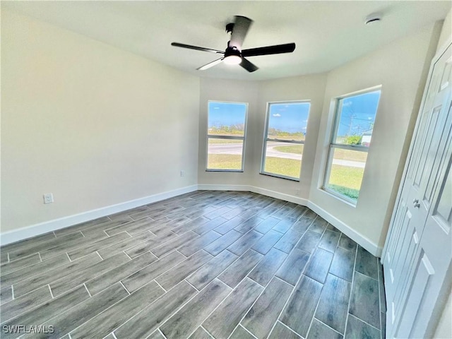 spare room featuring ceiling fan and plenty of natural light