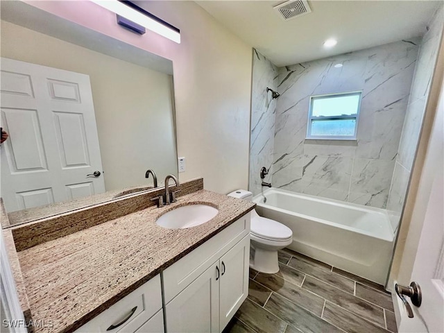 full bathroom with vanity, toilet, and tiled shower / bath