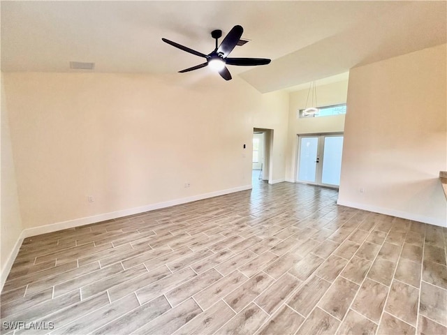 unfurnished room with french doors, ceiling fan, high vaulted ceiling, and light wood-type flooring