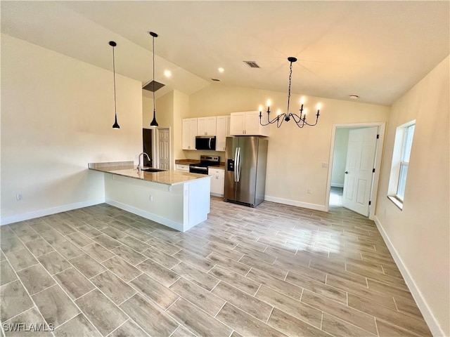 kitchen featuring sink, stainless steel appliances, white cabinets, decorative light fixtures, and a chandelier