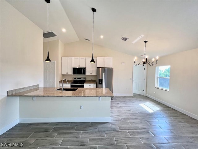 kitchen featuring sink, white cabinetry, an inviting chandelier, appliances with stainless steel finishes, and light stone countertops