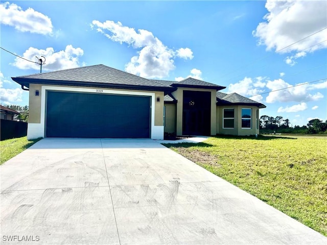 view of front of property with a garage and a front lawn