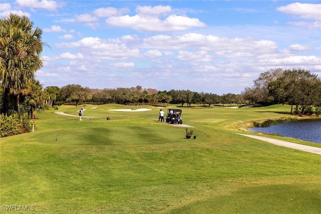 surrounding community with a lawn and a water view