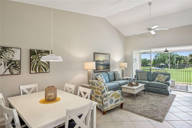 living room featuring ceiling fan, vaulted ceiling, and light tile patterned floors