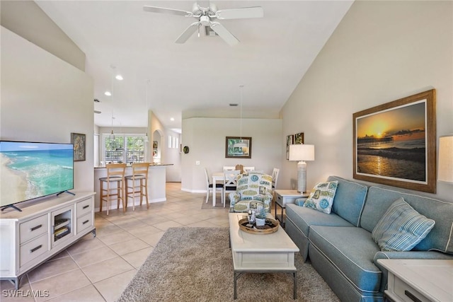 living room with light tile patterned flooring, ceiling fan, and lofted ceiling