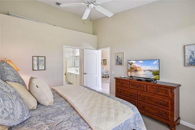 carpeted bedroom with connected bathroom and ceiling fan