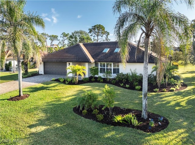 single story home with a garage and a front lawn