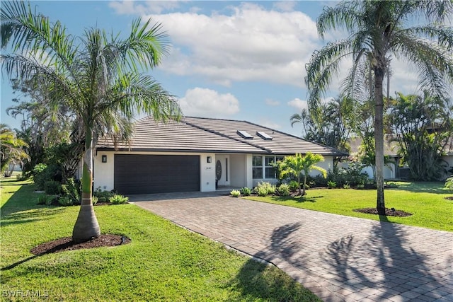 ranch-style home with a garage and a front yard