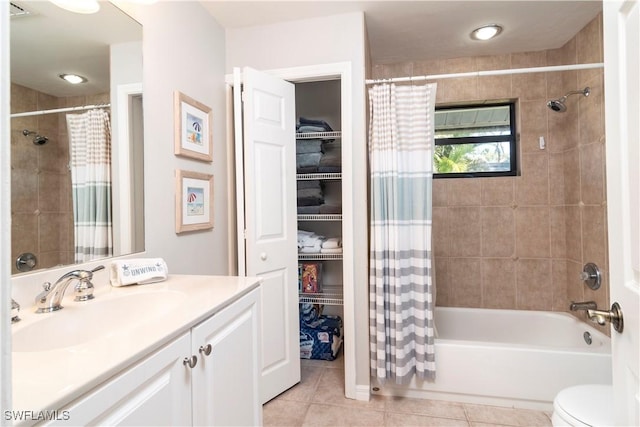 full bathroom with vanity, shower / bathtub combination with curtain, tile patterned floors, and toilet