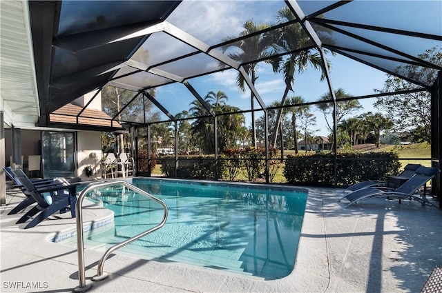 view of swimming pool featuring a lanai and a patio area