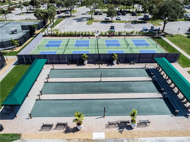 view of community featuring tennis court