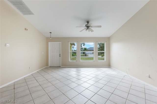 spare room with ceiling fan and light tile patterned flooring