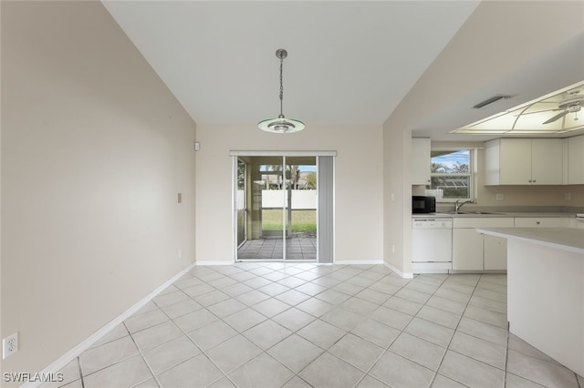 unfurnished dining area featuring vaulted ceiling, light tile patterned flooring, and sink