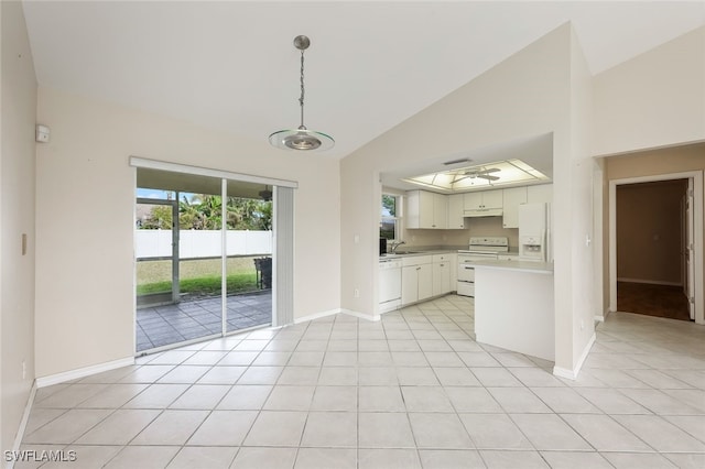 kitchen featuring light tile patterned floors, decorative light fixtures, white appliances, lofted ceiling, and white cabinets