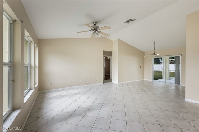 empty room with lofted ceiling, light tile patterned floors, ceiling fan, and french doors