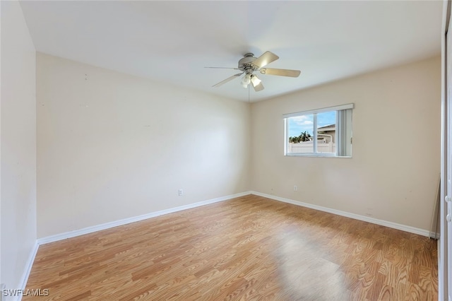 spare room with ceiling fan and light wood-type flooring