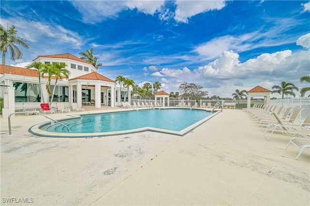 community pool featuring a patio, a gazebo, and fence