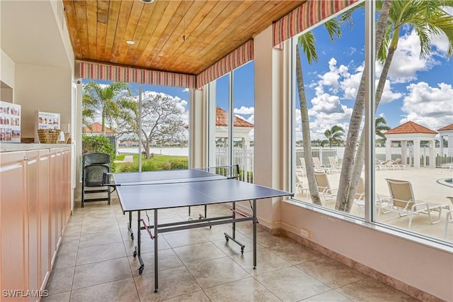 playroom with tile patterned flooring, wooden ceiling, and baseboards