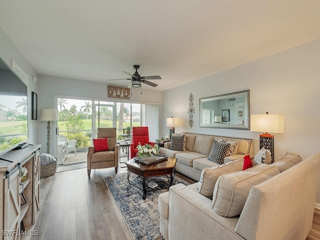 living room featuring hardwood / wood-style flooring and ceiling fan