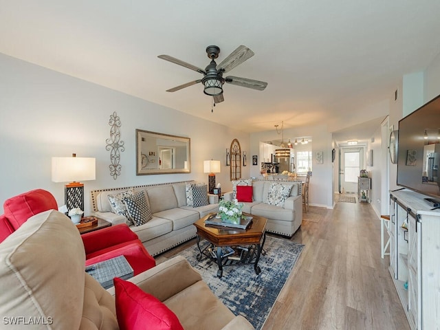 living room featuring light wood-type flooring and ceiling fan