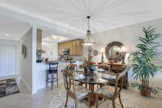 dining area with light tile patterned floors, ornamental molding, and a chandelier