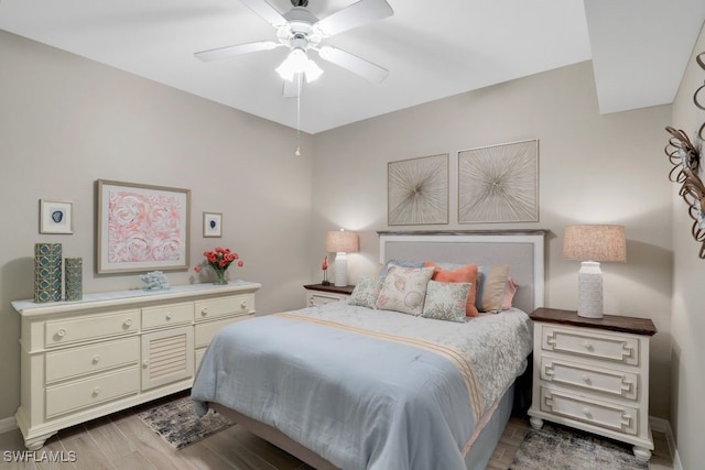 bedroom featuring light wood-type flooring and ceiling fan