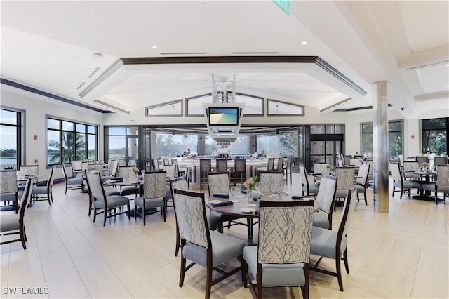 dining area featuring vaulted ceiling with beams