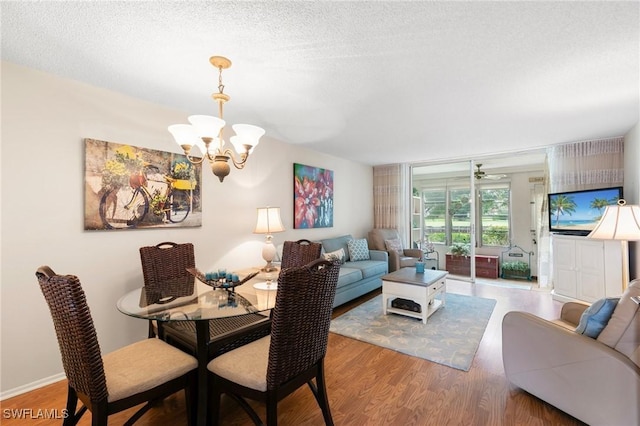 dining space featuring a notable chandelier, a textured ceiling, and hardwood / wood-style floors