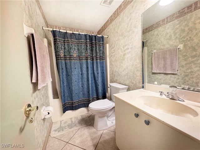 full bathroom with tile patterned floors, vanity, toilet, and shower / bath combination with curtain