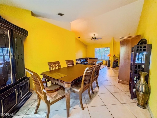 dining area featuring vaulted ceiling, ceiling fan, and light tile patterned flooring