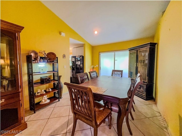 tiled dining area with lofted ceiling