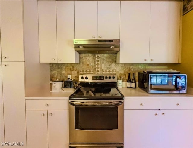 kitchen with backsplash, white cabinets, and stainless steel appliances