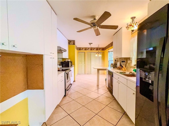 kitchen featuring light tile patterned flooring, white cabinetry, appliances with stainless steel finishes, and hanging light fixtures