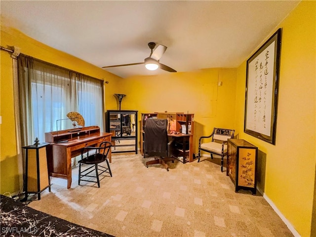 office space with ceiling fan and light colored carpet