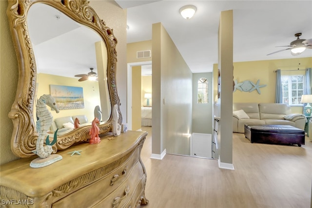 hallway featuring plenty of natural light and light hardwood / wood-style floors