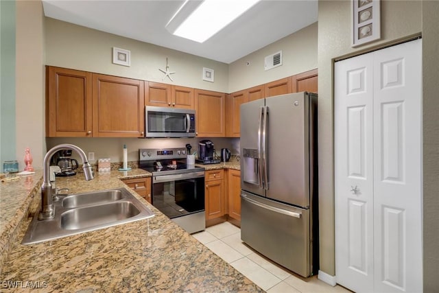 kitchen featuring light tile patterned floors, sink, and stainless steel appliances